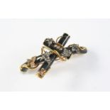 A VICTORIAN DIAMOND, BLACK ENAMEL AND GOLD MOURNING BROOCH formed as a cross, embossed with rose-cut