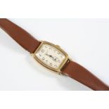 A GOLD WRISTWATCH BY J.W. BENSON, LONDON the signed tonneau-shaped dial with Arabic numerals and