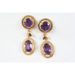 A PAIR OF AMETHYST AND GOLD DROP EARRINGS each earring mounted with a circular-cut amethyst