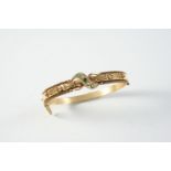 A GOLD, EMERALD AND DIAMOND HALF HINGED BANGLE set to one side with embossed rope and ball