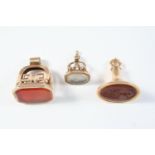 THREE ASSORTED GOLD SEALS one with carnelian matrix engraved with a coat of arms, 3.7cm high, one