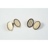 A PAIR OF 18CT GOLD AND ENAMEL CUFFLINKS of oval form, each link with white enamel and gold