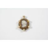 A VICTORIAN CARVED HARDSTONE CAMEO PENDANT depicting the profile of a classical woman, set within