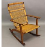 DANISH DESIGNER ROCKING CHAIR - 'JK' a rocking chair with a teak frame, and a woven seat and back.