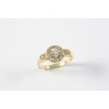 A DIAMOND CLUSTER RING the cushion-shaped old-cut diamond is set within a surround of old-cut