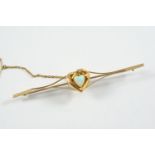 AN OPAL AND GOLD HEART BROOCH the heart-shaped opal is set within a gold heart mounted with a