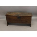 AN 18TH CENTURY OAK SIX PLANK COFFER. The broad top with strap hinges and chain fastening, the front