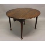 A GEORGE II DROP FLAP TABLE. With an oval top with moulded border, on turned tapering legs with