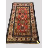 GENDJE RUG, CENTRAL CAUCASUS, CIRCA 1900 The madder field with four latch hook guls enclosed by