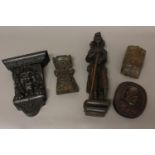 A 17TH CENTURY CARVED OAK STANDING FIGURE AND FOUR SIMILAR ITEMS. A carved standing figure of a