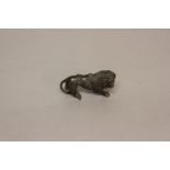 AFTER THE ANTIQUE: CAST BRONZE LION. A small cast bronze lion wearing a saddle held in place with