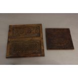 A PENWORK CEDAR PANEL AND A CARVED DOOR PANEL. A square cedar wood panel with pen work decoration of