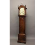 AN EARLY 19TH CENTURY MAHOGANY LONGCASE CLOCK. With an arched painted dial with Roman numerals and