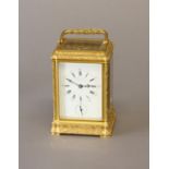 A 19th CENTURY FRENCH CARRIAGE CLOCK AND TRAVELLING CASE. With a rectangular white enamelled dial