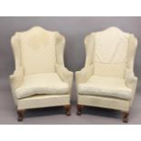 A PAIR OF QUEEN ANNE STYLE WING BACK ARM CHAIRS. With arch topped rectangular backs, outscrolling