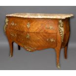 A LOUIS XVI STYLE MARBLE TOPPED COMMODE. The variegated marble top with serpentine front and moulded