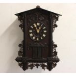 A LATE 19TH CENTURY AUSTRIAN BLACK FOREST 'TRUMPETER' WALL CLOCK. the oak case carved with leaves