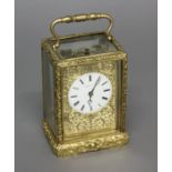 AN ELABORATE GILT BRASS CARRIAGE CLOCK BY HENRY OF PARIS. With a white enamelled dial with Roman