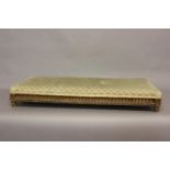 A VICTORIAN GILT WOOD UPHOLSTERED LONG STOOL. The rectangular top upholstered, on a fluted and