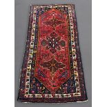 KUBA RUG, NORTH EAST CAUCASUS, CIRCA 1910 The tomato red field centred by a stylised flower head