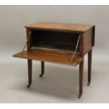 A VICTORIAN MAHOGANY DROP FLAP DECEPTION TABLE, with fall front enclosing a vacant interior, on