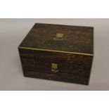 A VICTORIAN COROMANDEL AND BRASS TRAVELLING BOX. The rectangular top with brass border and central