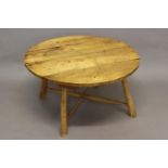 A RUSTIC HOLLY WOOD CIRCULAR TOP TABLE. With a four plank pale timber top of tapering legs with