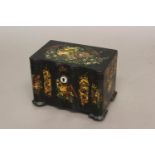 A REGENCY OR EARLY VICTORIAN LACQUERED TEA CADDY. With a moulded front and flat top all over