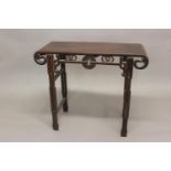A CHINESE HARDWOOD ALTAR TABLE. The rectangular top with central panel and scrolling ends with