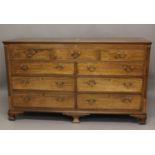 A GEORGE III MAHOGANY HALL CHEST with hinged top, drawers and dummy drawers in the front and