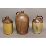 A LARGE 19TH CENTURY STONEWARE FLAGON AND TWO SIMILAR. A large salt glazed stoneware flagon with