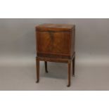 A GEORGE III MAHOGANY CELLARETTE crossbanded and on tapering legs; 39 cms