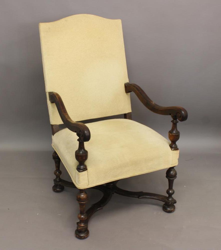 A WILLIAM AND MARY STYLE OPEN UPHOLSTERED ARM CHAIR. With an arch topped rectangular back, scrolling