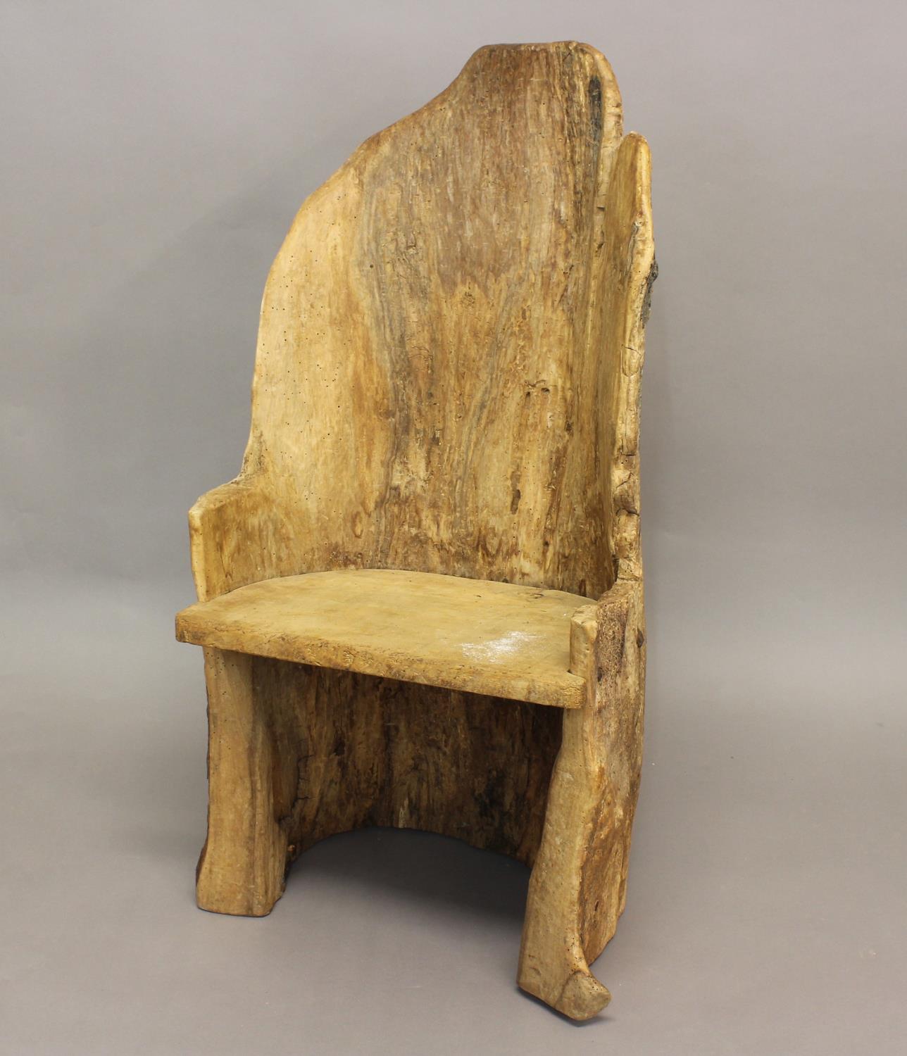 A PRIMITIVE 'DUG OUT' TYPE CHAIR. An unusual 'dug out tree trunk' type chair with solid seat,