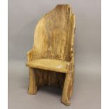 A PRIMITIVE 'DUG OUT' TYPE CHAIR. An unusual 'dug out tree trunk' type chair with solid seat,