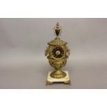 AN ELABORATE URN SHAPED MANTEL CLOCK. The clock with a black dial with gilt Roman numerals, with