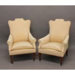 A PAIR OF LATE VICTORIAN/EDWARDIAN UPHOLSTERED ARM CHAIRS. Each with raised, shaped, rectangular