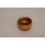 A 19TH CENTURY LIGNUM VITAE BOWL. Of small turned construction with flat bottom, 5cm high, 9cm