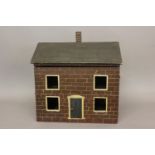 A MID 19TH CENTURY 'FOLK ART' DOLLS HOUSE. The house with a central brick chimney above a pitched