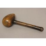 A 19TH CENTURY MALLET. An unusual 19th century mallet with a turned handle and tapering circular