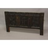 A 17TH CENTURY OAK COFFER FRONT. A three panel oak coffer front, the central panel with an arch