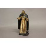 AN EARLY 18TH CENTURY FRENCH CARVED DEVOTIONAL FIGURE. A polychrome figure of St Anthony in a