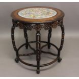 A CHINESE HARDWOOD OCCASIONAL TABLE the circular top inset with a porcelain plaque painted in a "