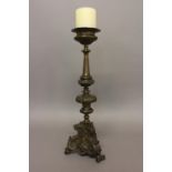 A MID 18TH CENTURY ITALIAN ALTAR CANDLESTICK. A baroque style candlestick with a flared drip pan