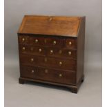 AN UNUSUAL GEORGE II MAHOGANY BUREAU. With a sloping fall with moulded edge enclosing a fitted