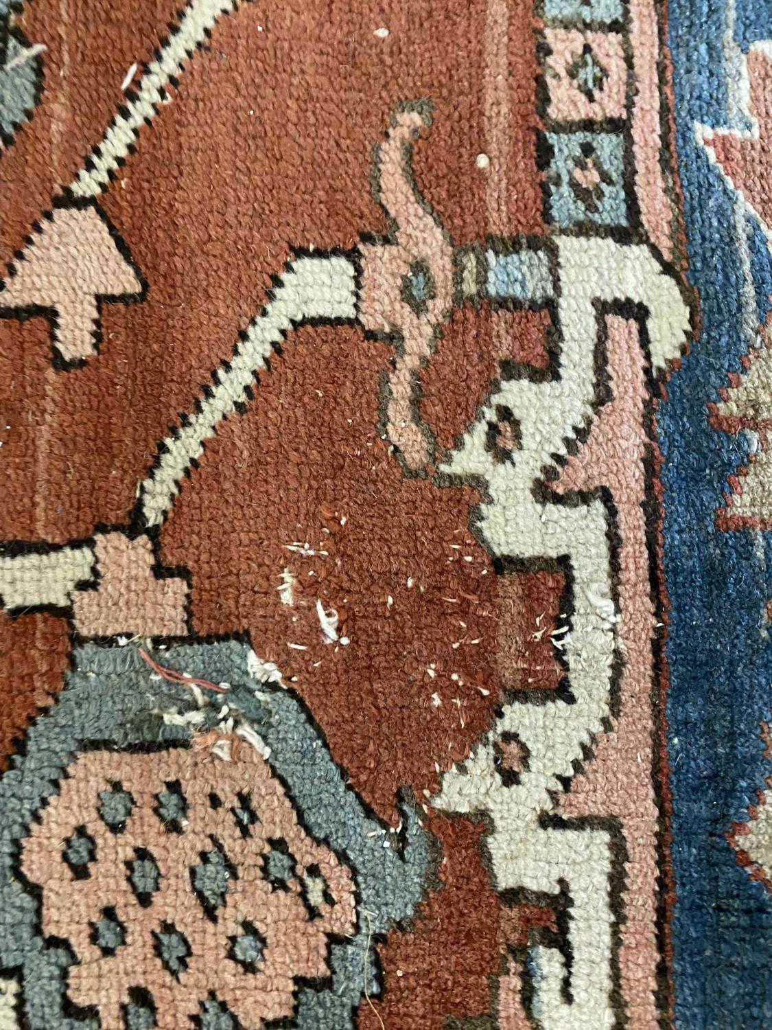 A HERIZ CARPET c1870. Iranian Azerbaijan, The stepped terracotta fields centred by an indigo and - Image 3 of 16