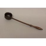 AN EARLY 19TH CENTURY TREEN PUNCH LADLE. With a slender handle with shaped end and straight shaft