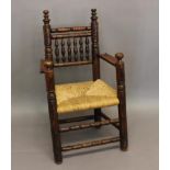 A FRUITWOOD TURNERS CHAIR. With heavy turned uprights, the rail back with six turned uprights,