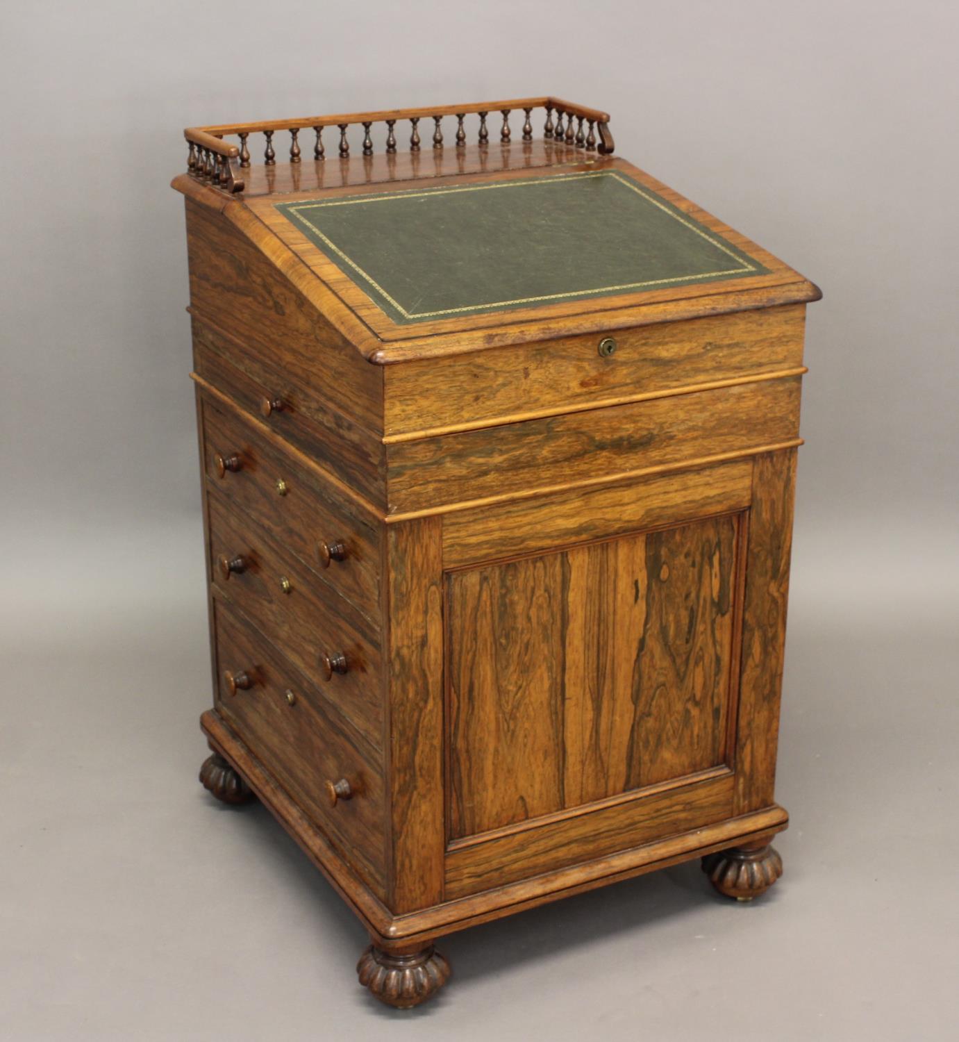 A GEORGE IV ROSEWOOD DAVENPORT. With a sloping leather lined writing surface and galleried top,