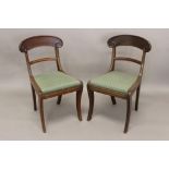 A SET OF EIGHT LATE REGENCY MAHOGANY DINING CHAIRS. Each with broad curved backs with scrolling